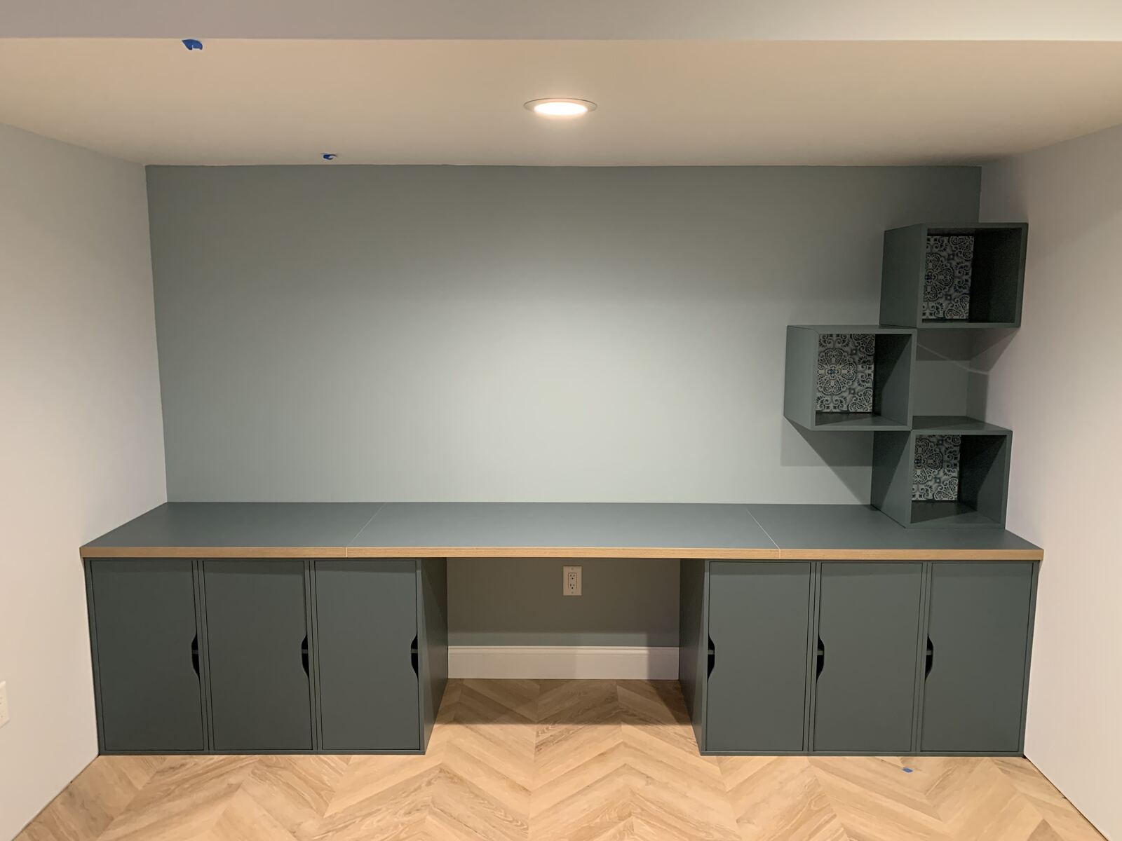 Finished IKEA storage cabinets, desk and cubby shelving, assembled and fitted to the wall