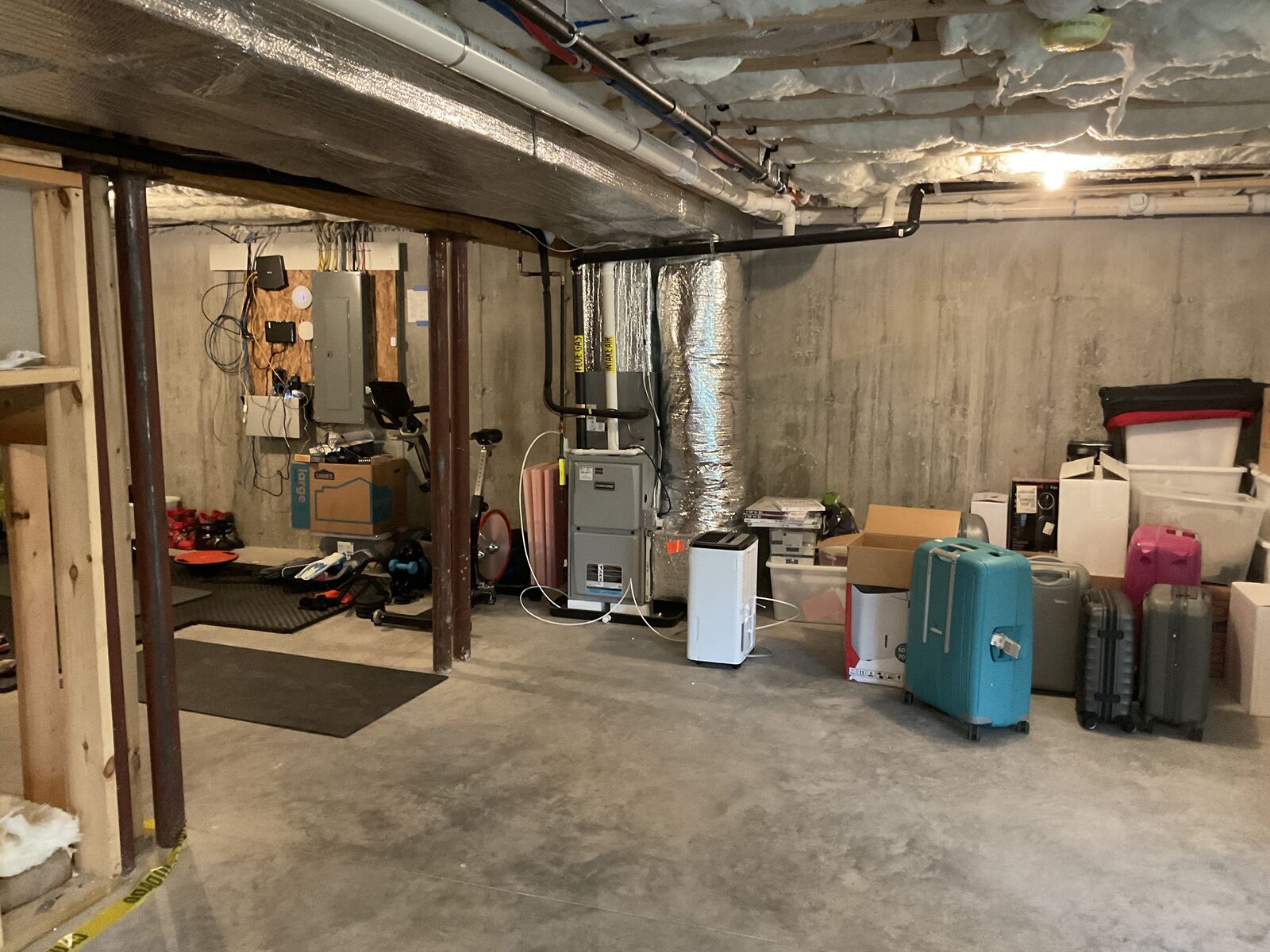 Unfinished basement storage area before the build-out