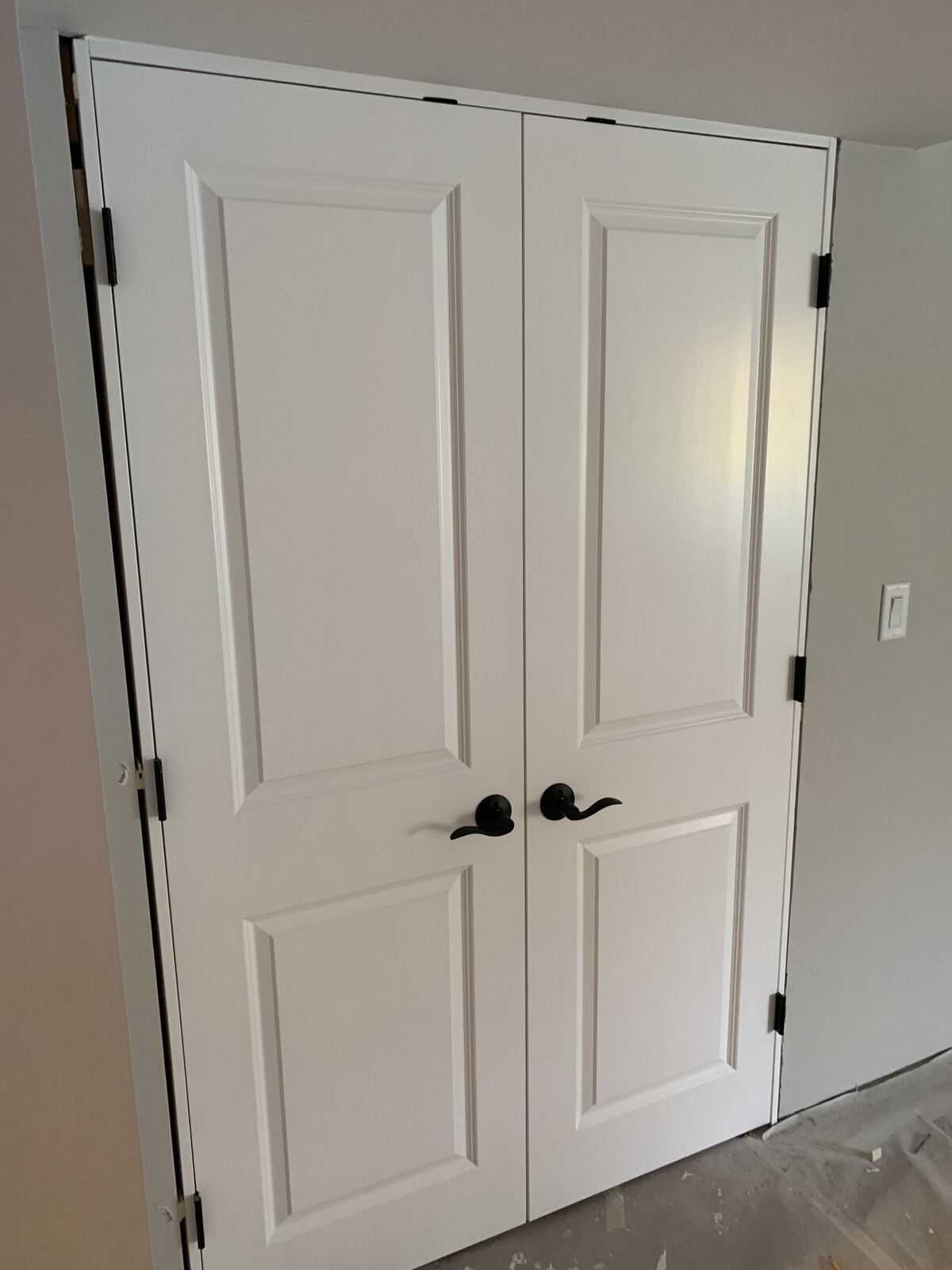 Newly installed white double closet doors
