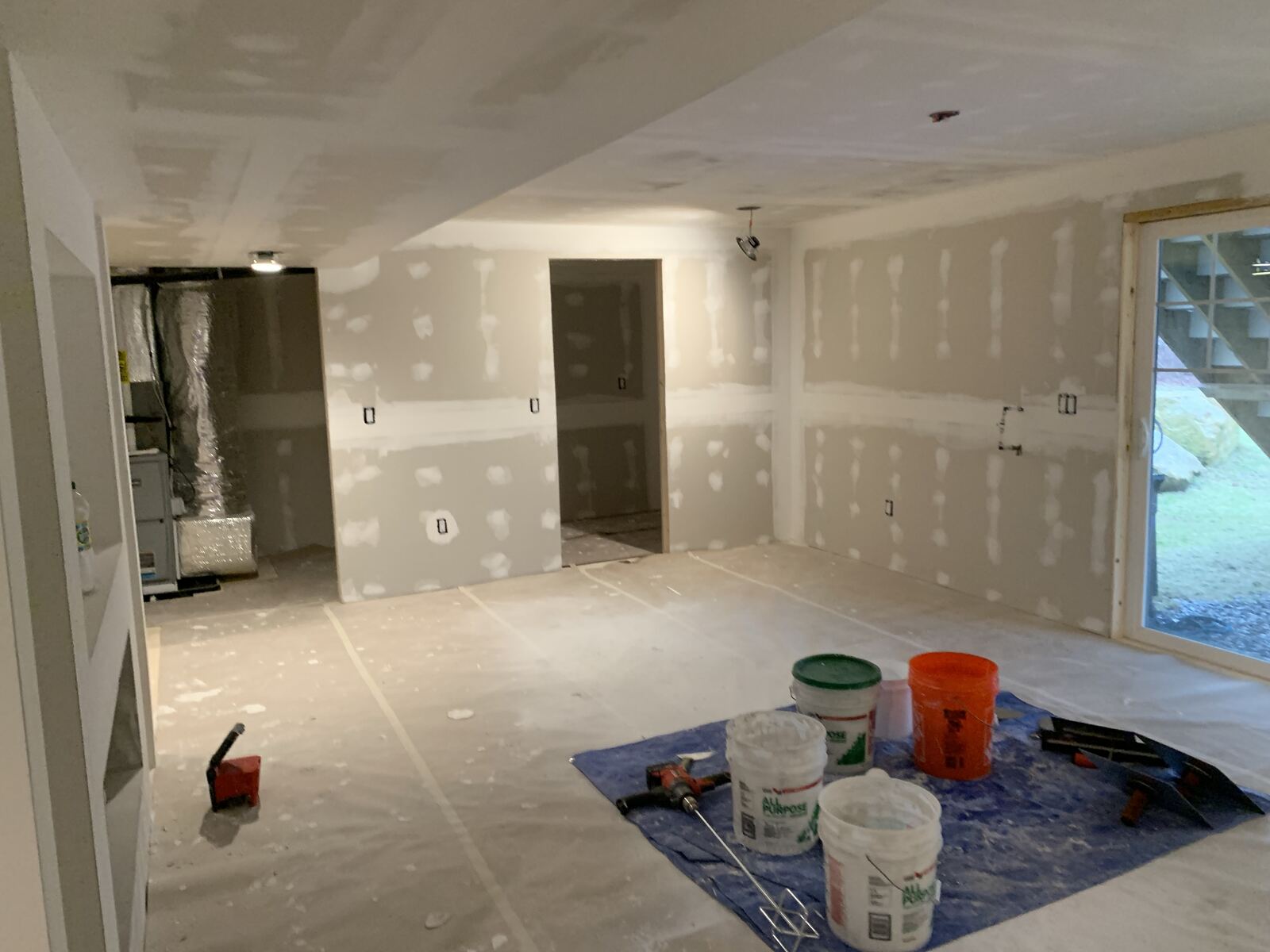 Basement room mid-project with drywall hung and mudded